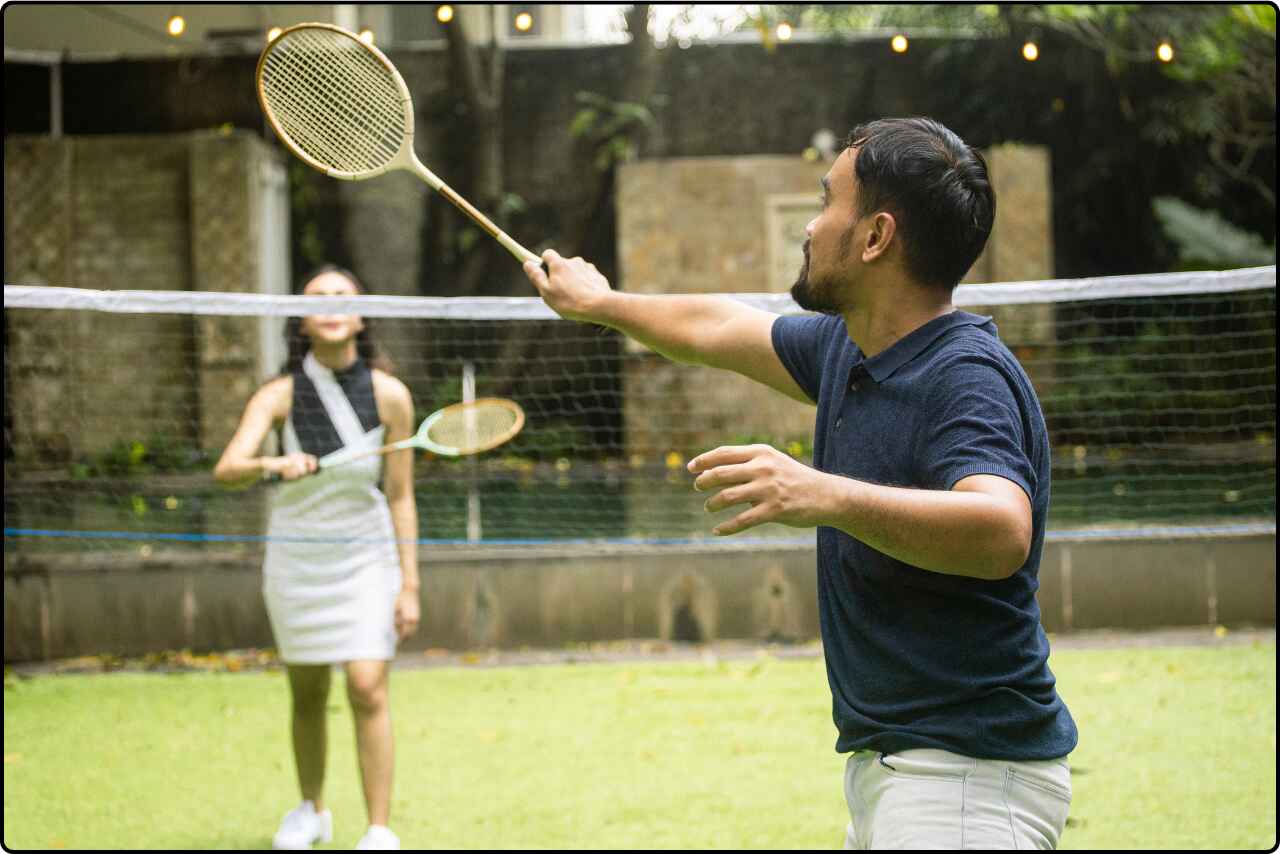 Friends in action, hitting the shuttlecock in a badminton game.